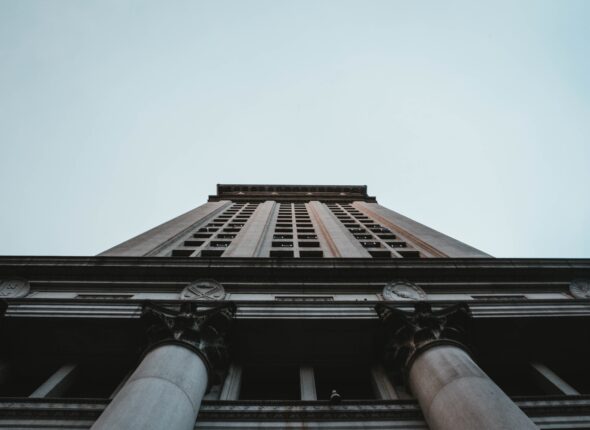 A low angle shot of a tall business building in NYC